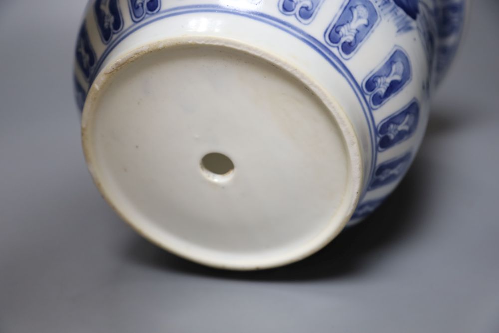 A Chinese blue and white jardiniere, a green glazed lion dog and a famille rose dish
